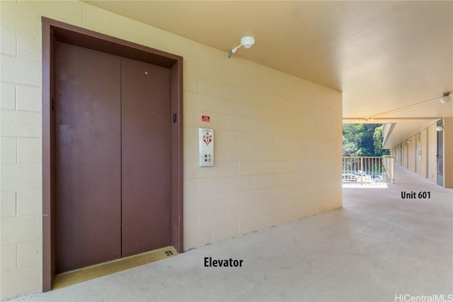 property entrance with concrete block siding and elevator