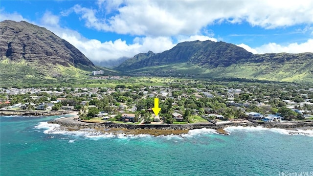 drone / aerial view featuring a water and mountain view