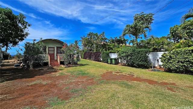 view of yard with a wooden deck and fence