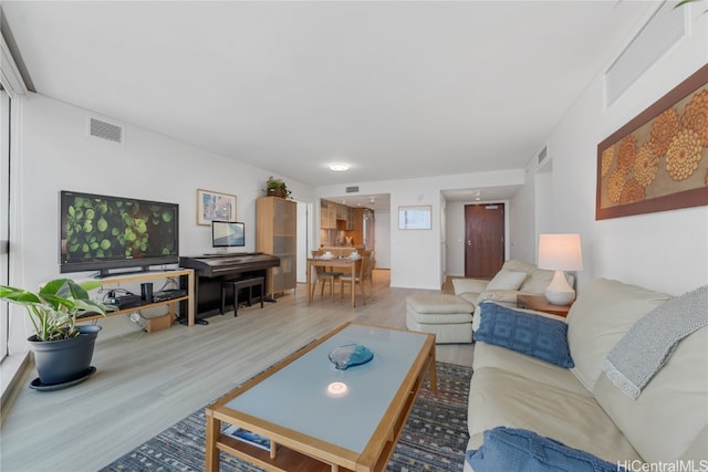 living area featuring wood finished floors and visible vents