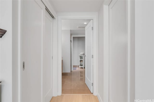 corridor with light wood-type flooring