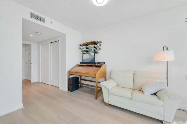 sitting room featuring wood finished floors, visible vents, and baseboards