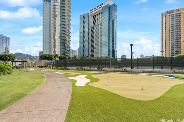 surrounding community with a city view and fence