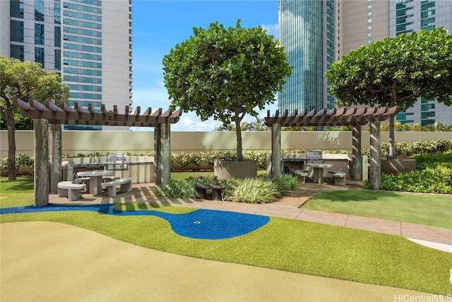 view of home's community with exterior kitchen, a pergola, and a patio