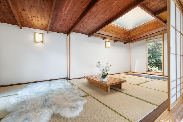 unfurnished sunroom with beam ceiling and wood ceiling