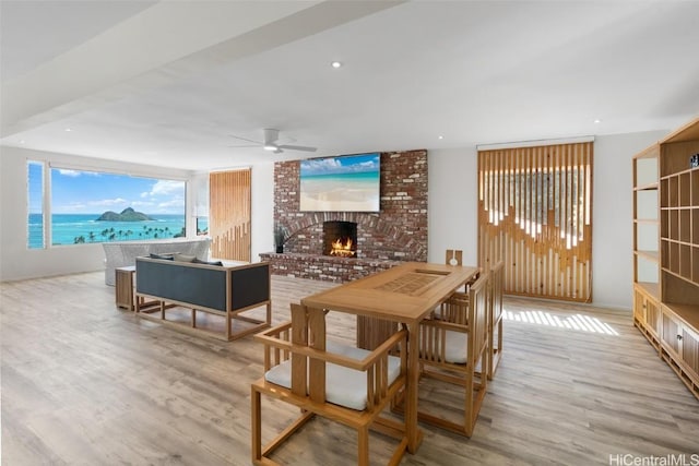 dining space featuring recessed lighting, a fireplace, wood finished floors, and a ceiling fan