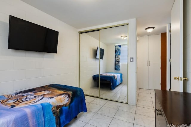 bedroom featuring light tile patterned floors and a closet