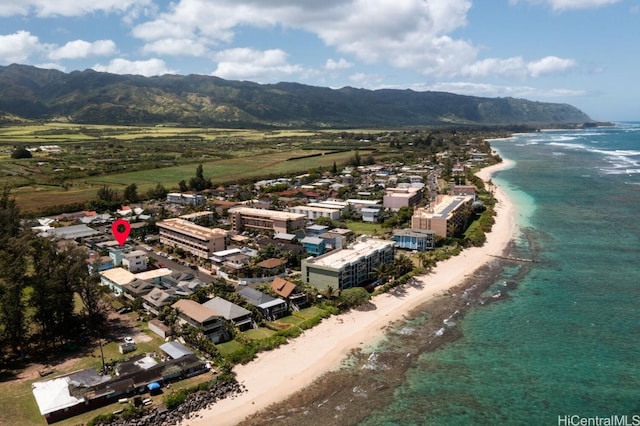 aerial view with a water and mountain view and a view of the beach