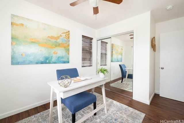 office area featuring a ceiling fan, wood finished floors, and baseboards