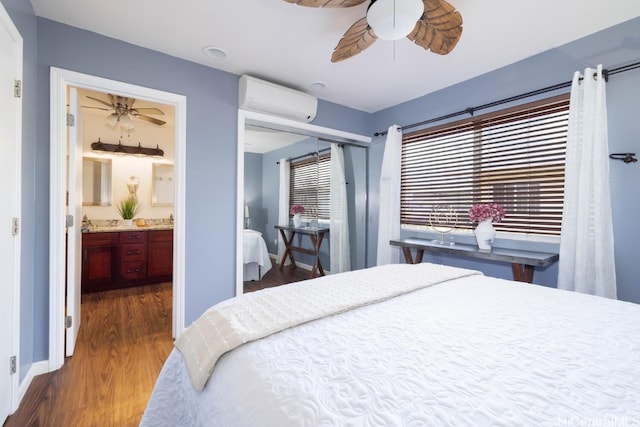 bedroom featuring baseboards, ceiling fan, an AC wall unit, a closet, and dark wood-style floors