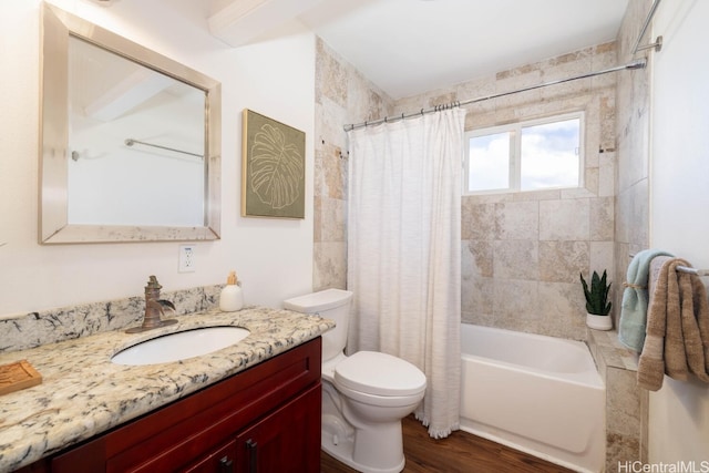 bathroom with vanity, toilet, wood finished floors, and shower / tub combo with curtain