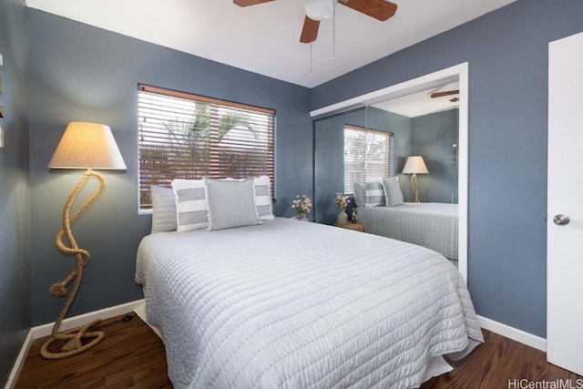 bedroom with a ceiling fan, baseboards, and wood finished floors