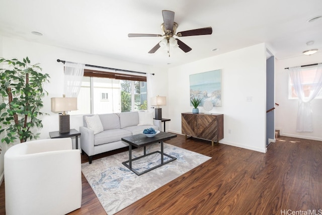 living room featuring a ceiling fan, wood finished floors, and baseboards