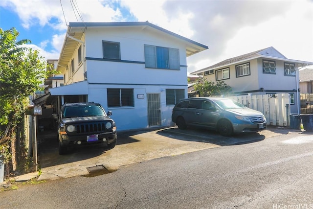 view of front of home featuring fence