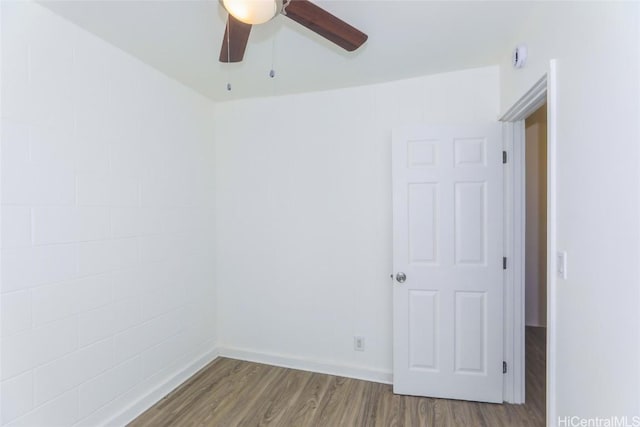 empty room featuring a ceiling fan and wood finished floors