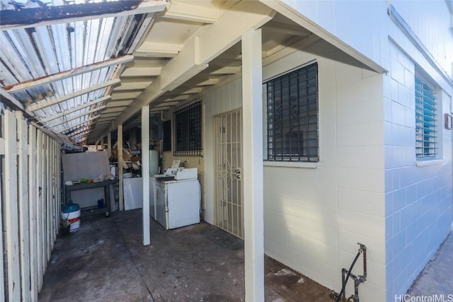 view of side of property with washer / dryer and concrete block siding