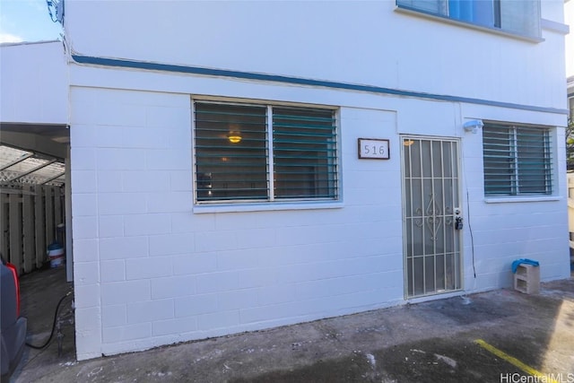 entrance to property featuring concrete block siding