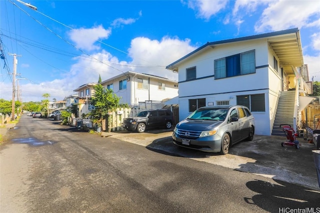 view of front of property featuring a residential view and stairs