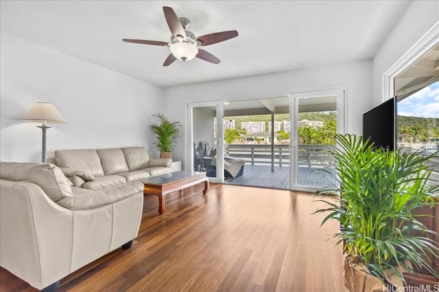 living room with a ceiling fan and wood finished floors