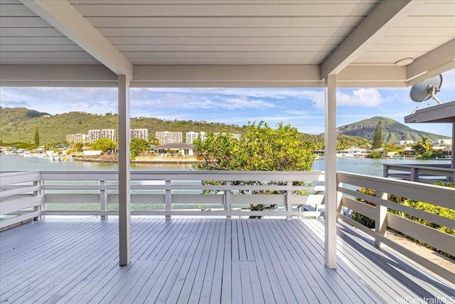 deck with a water and mountain view