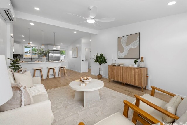 91-1046 Kauiki St, Ewa Beach, HI 96706 - living area with light wood finished floors, a wall mounted AC, vaulted ceiling with beams, recessed lighting, and ceiling fan