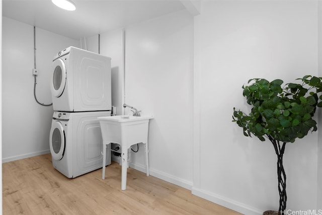 91-1046 Kauiki St, Ewa Beach, HI 96706 - washroom featuring laundry area, stacked washer / dryer, baseboards, and light wood-type flooring