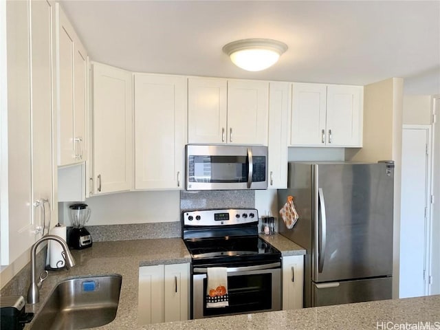 kitchen featuring a sink, white cabinets, and stainless steel appliances