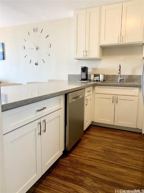 kitchen with dishwasher, white cabinets, dark wood-style floors, and a sink