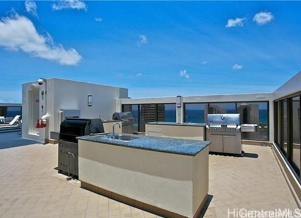 view of patio featuring a sink, area for grilling, and grilling area