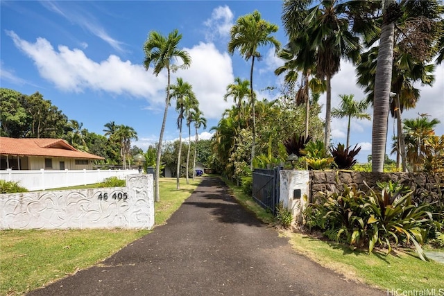 view of road with aphalt driveway and a gated entry