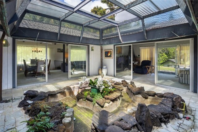 rear view of house featuring a lanai and a patio area