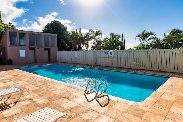 pool featuring a patio and fence