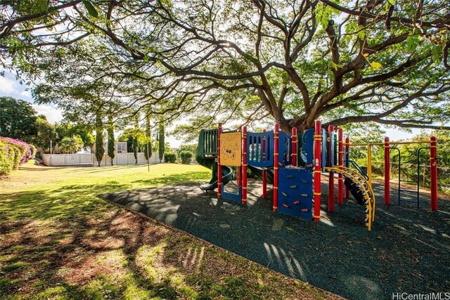 community playground with a yard and fence