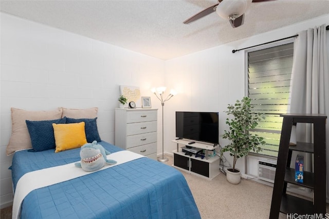 carpeted bedroom featuring a textured ceiling and ceiling fan