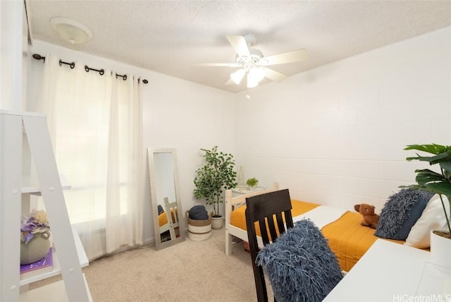 interior space with light colored carpet, a textured ceiling, and a ceiling fan