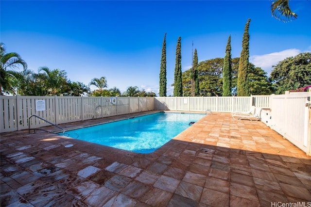 community pool featuring a patio area and fence