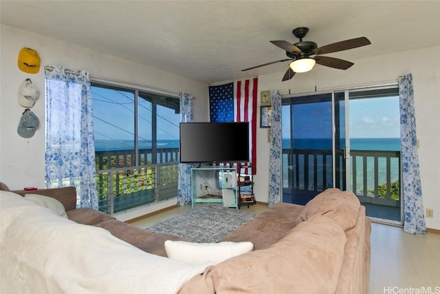 living area featuring wood finished floors and ceiling fan