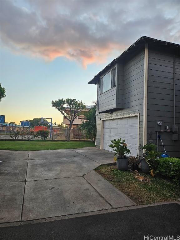 view of property exterior featuring a garage and driveway