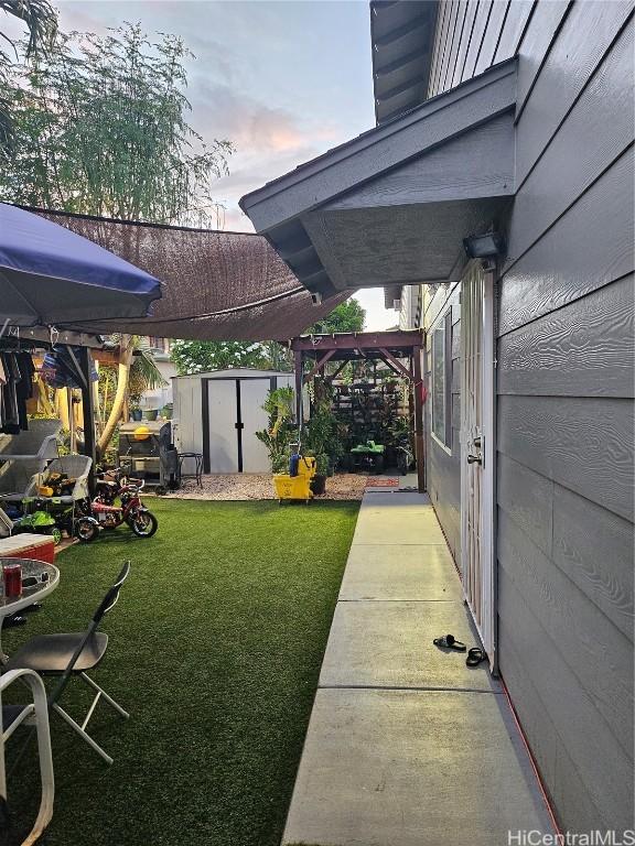 view of yard with an outbuilding and a shed