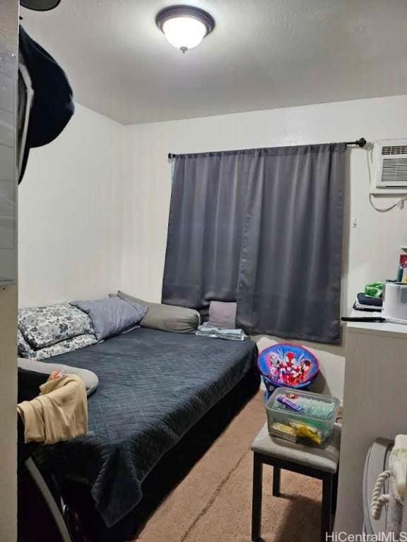 carpeted bedroom with a wall mounted air conditioner