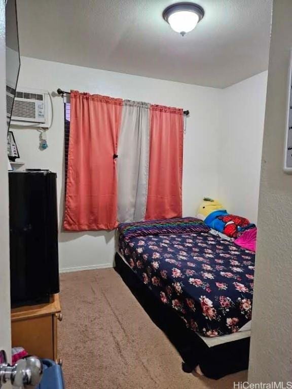 carpeted bedroom with an AC wall unit