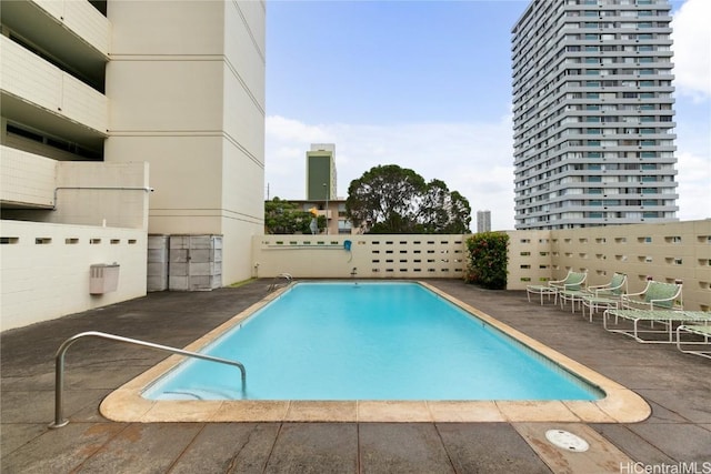 pool with a city view and a patio area