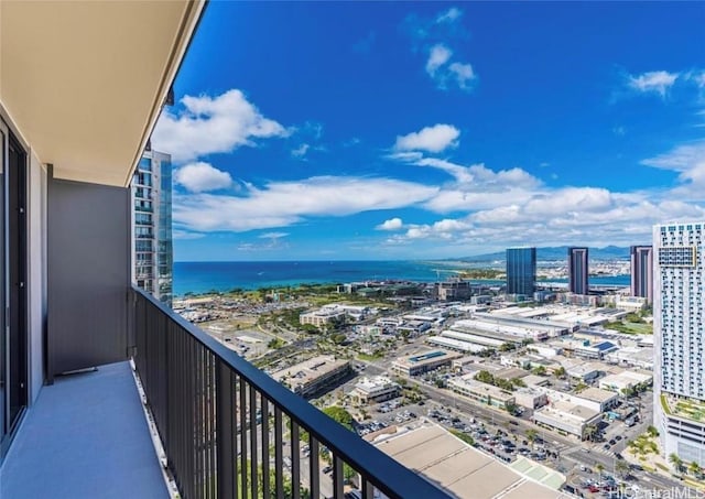 balcony with a water view and a city view