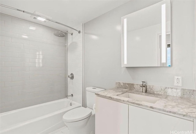 bathroom featuring toilet, vanity, and bathtub / shower combination