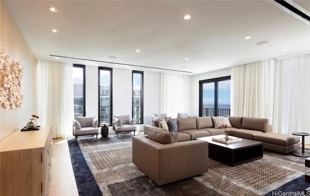 living area featuring recessed lighting, expansive windows, and wood finished floors