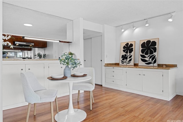 581 Kamoku St Unit 504, Honolulu, HI 96826 - dining room with light wood finished floors and track lighting