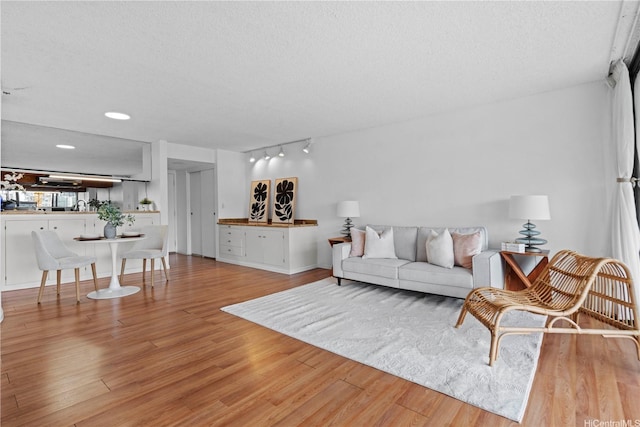 581 Kamoku St Unit 504, Honolulu, HI 96826 - living area with light wood finished floors, a textured ceiling, and track lighting