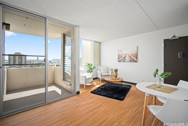 interior space with floor to ceiling windows, a textured ceiling, and wood finished floors