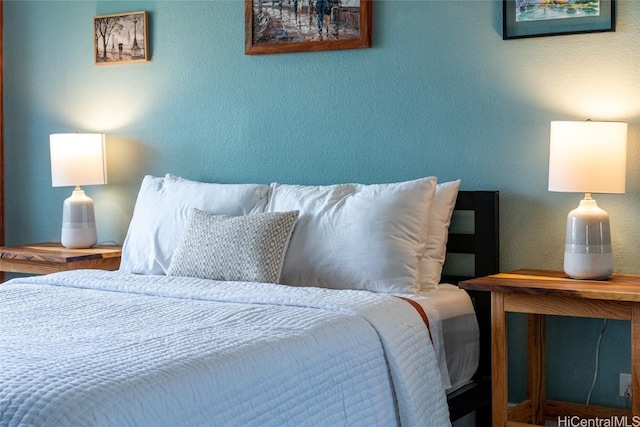 bedroom featuring a textured wall