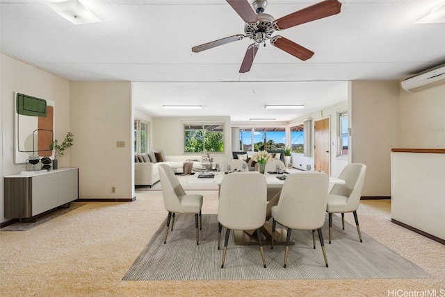 dining room with a healthy amount of sunlight, a wall mounted AC, baseboards, and carpet floors